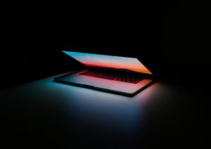 Laptop in dark room - the benefits of using technology
