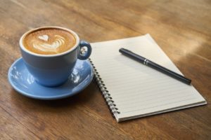 Coffee and notepad - conducting a SWOT analysis