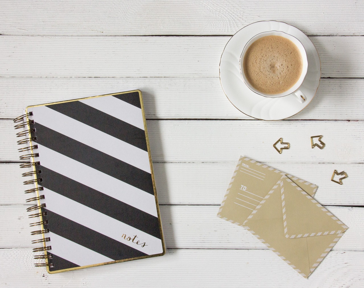 Envelope, coffee and stationery - email marketing tip