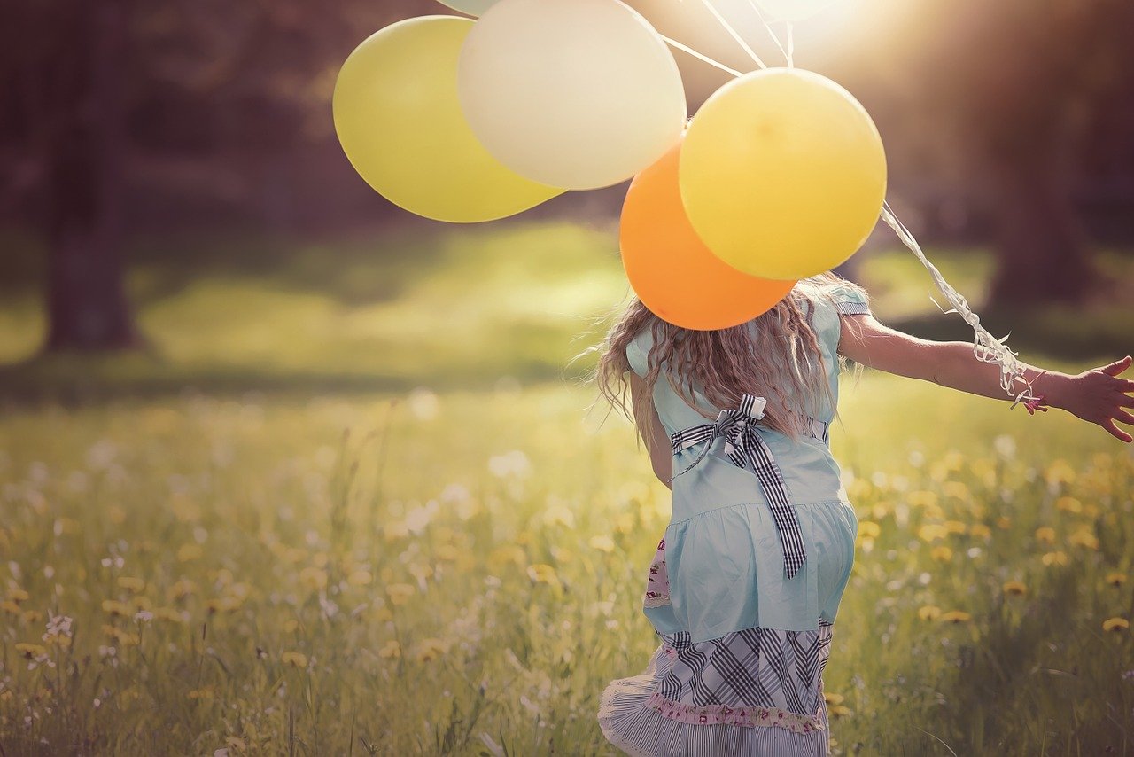 Happy woman with balloons - creating a personal brand