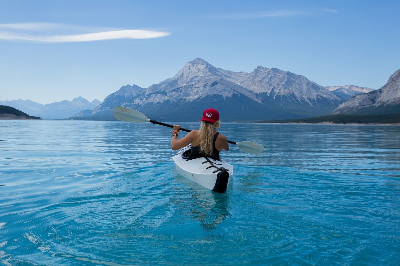 Girl Kayaking in Blue Water